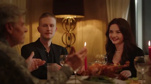 People sitting in a restaurant holding hands while praying before dinner. A Stock Footage 237595053
