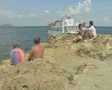 People sitting on rock by sea SD Footage