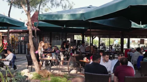 People sitting on summer cafe in the evening. Antalya, Turkey- 04.23.2022 Video stock 201112902