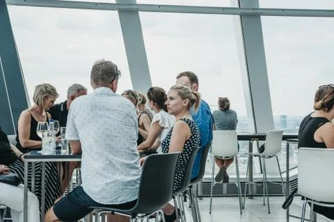 People sitting at a table inside Sky Garden, London, UK. Stock Photos