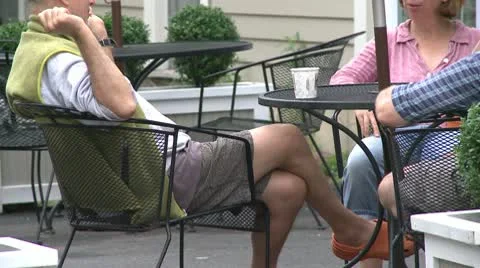 People sitting at a table at a sidewalk cafe chatting Video stock 10770689