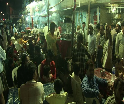 People sitting at tables in crowded night market Stock Footage 86742272