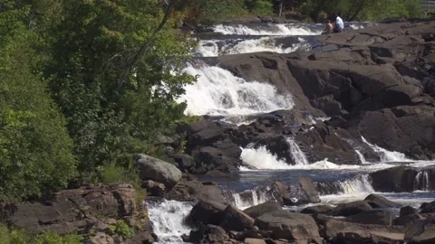 People sitting at the top of waterfalls Stock Footage 213310084