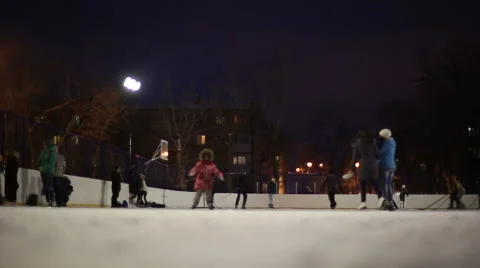 People skate on the outdoor ice rink Stock Footage 59142623