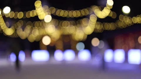 People skating blurred in background, festive atmosphere winter Stock Footage 322762086