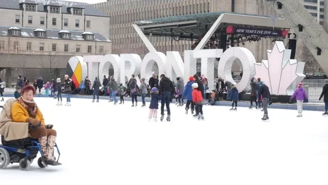 People skating in front of Toronto city hall Stock Footage 100507191