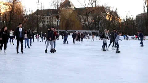 People skating on ice in the park Stock Footage 84151085