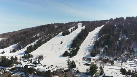 People skiing on the mountain slopes covered of snow in St-Sauveur Stock-Footage 164420136