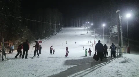 People skiing at night Stock Footage 46034352