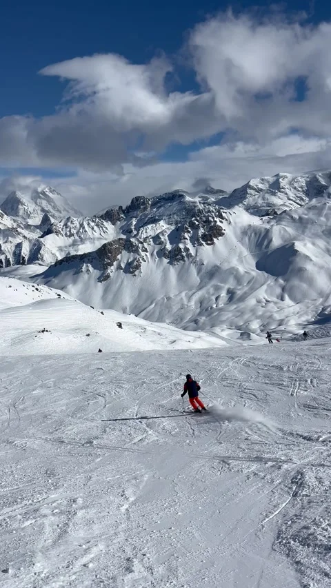 People skiing on the slopes of Courchevel ski resort by winter Stock Footage 336928587