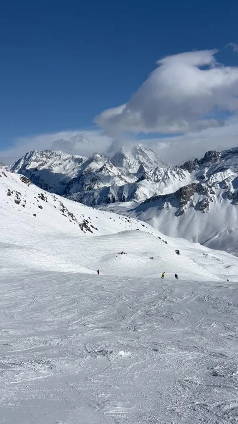 People skiing on the slopes of Courchevel ski resort by winter Stock Footage 336928701
