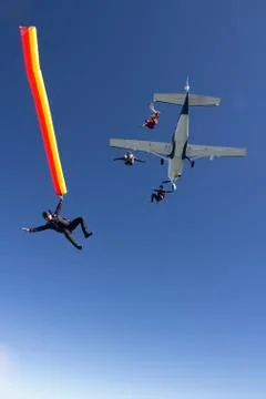 People skydiving from plane Stock Photos