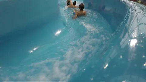 People slide down a water slide 스톡 동영상 79541503