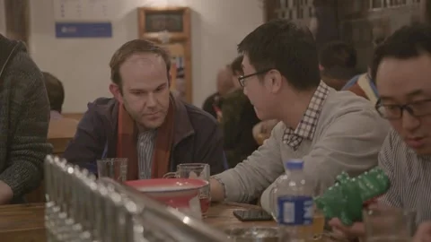 People Socializing and Drinking at Bar Table in Beijing China Evening Indoor Stock Footage 345751209