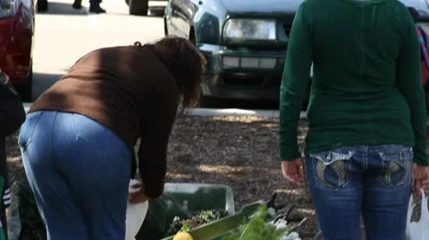 People sort through fresh vegetables at Farmer's market Stock Footage 21543497