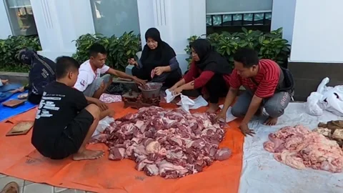 People sorting and cutting raw meat on tarps Stock Footage 279445601