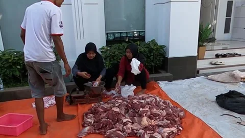 People sorting and preparing raw meat outdoors Stock Footage 279445590