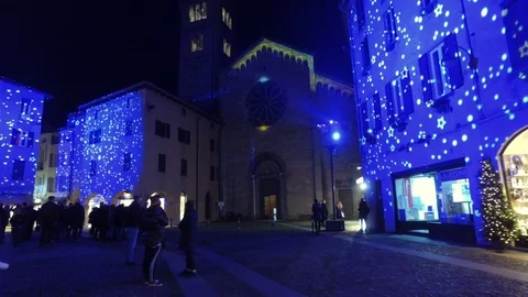 People in the square look at the lights projected on the city of Como. Stock Footage 99460463