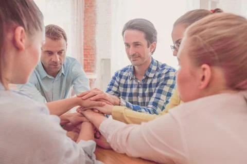 People stacking hands Stock Photos