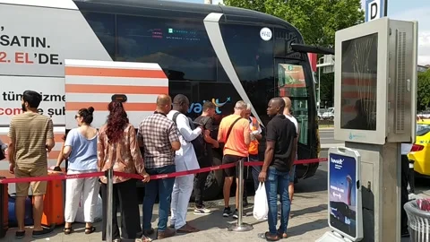 People Stand In Queue To Board At Bus Terminal, Istanbul Stock Footage 244673798