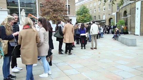 People stand in a queue at the exhibition. Stock Footage 62063993