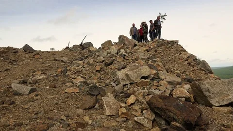 People stand on the rock at high elevation block of stone Stock Footage 73131837