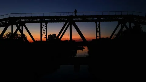 People stand on top of the bridge at sunset Stock Footage 205435390