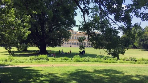 People stand under the trees at the Monza park Stock Footage 120529220