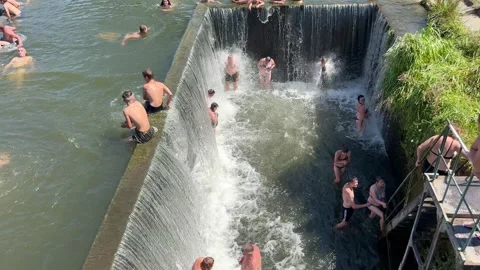 People stand under the waterfall Stock Footage 252317110