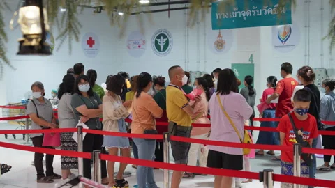 People Stand &amp; Wait In Line For Covid Flu Vaccination At Asia Indoor Clinic Stock-Footage 256065328