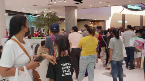 People Stand &amp; Wait In Line For Covid Flu Vaccination At Asia Indoor Clinic Stock Footage 256095147