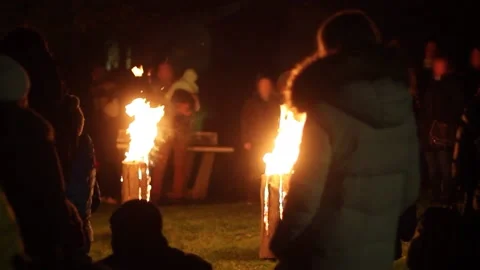 People standing around fire and singing Stock Footage