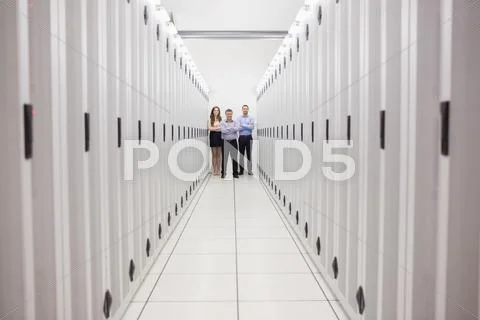 People standing in corridor of data center Stock Photos