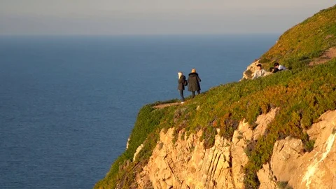 People standing at the edge of cliff in Cape Roca, Portugal Stock Footage 110761365