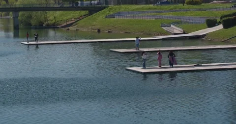 People standing on floating platforms on a lake 库存影片 332511099