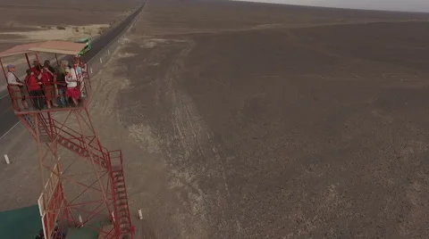 People standing at a high construction watching wonderful nazca lines Stock Footage 62852912