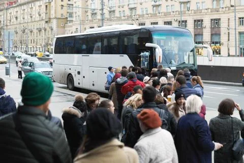 People standing in the long queue to the touristic bus Stock Photos