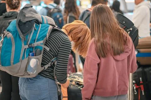 People standing with luggage in queue to check in in airport terminal. Tour.. Stock Photos