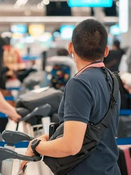 People standing with luggage in queue to check in in airport terminal. Tour.. Stock Photos