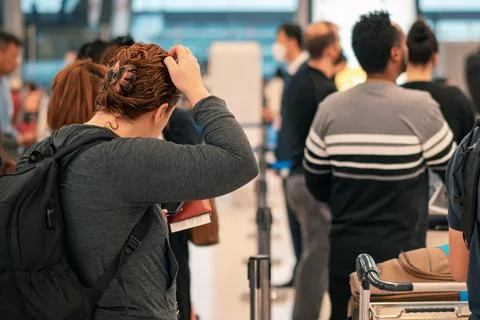 People standing with luggage in queue to check in in airport terminal. Tour.. Stock Photos