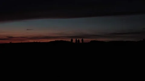 People standing on a mountain sunset Stock Footage 220736888