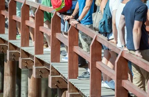 People standing in a queue on the bridge. Stock Photos