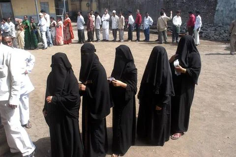 People standing in queue to cast their vote outside a polling booth during... Stock Photos