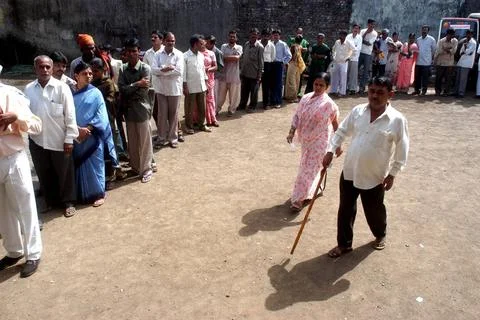 People standing in queue to cast their vote outside a polling booth during... Stock Photos