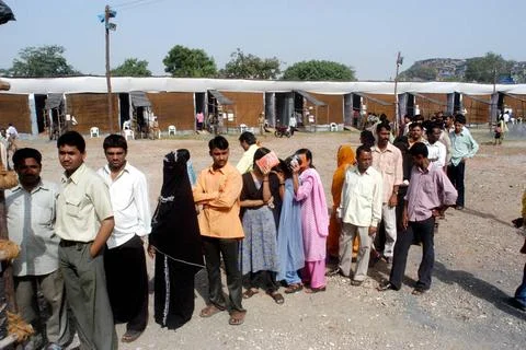 People standing in queue to cast their vote outside a polling booth during... Stock Photos