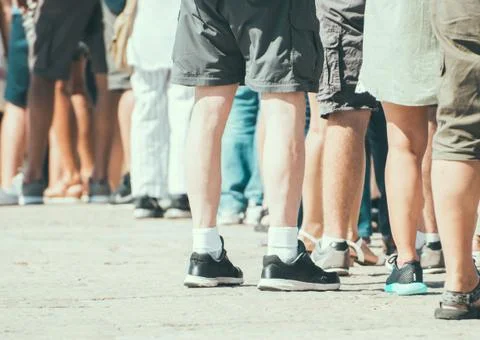 People standing in a queue on the street. Stock Photos