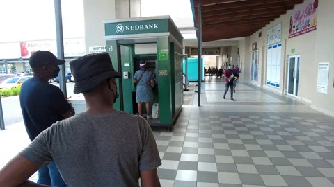 People standing in queue to withdraw money from Nedbank ATM. Video stock 169986777