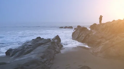 People Standing on Rocks as Waves Crash Stock Footage 101445678