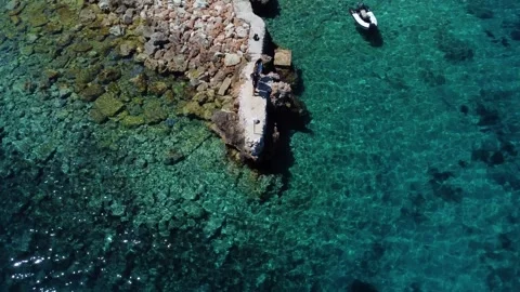 People standing on a small pier in crystal clear water Video stock 336937533