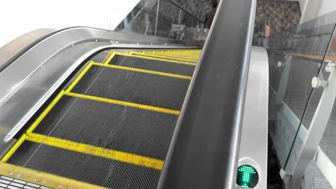 People step on escalator down. people tourists with luggage bags in airport Stock Footage 129114786